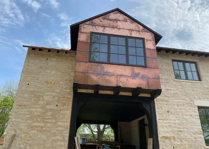 Copper metal panel facade on a stone building for Skylight Installation in Sumter