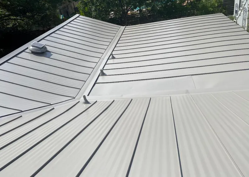 Solar attic fan installed on a metal roof for Roof Ventilation in Sumter